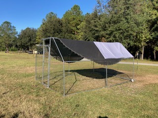 metal chicken coop in pasture