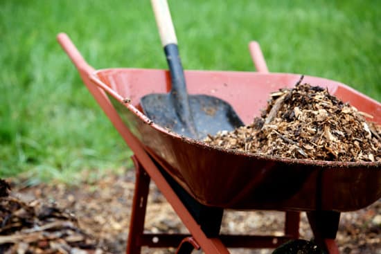 wheelbarrow with a shovel and mulch