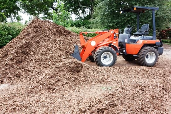 a front end loader getting a scoop of mulch
