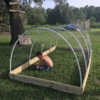 a boy helping build a chicken tractor
