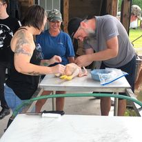 a couple learning to process a chicken