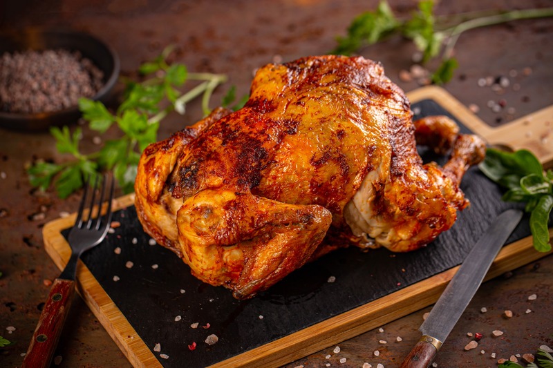 whole roasted chicken on carving board