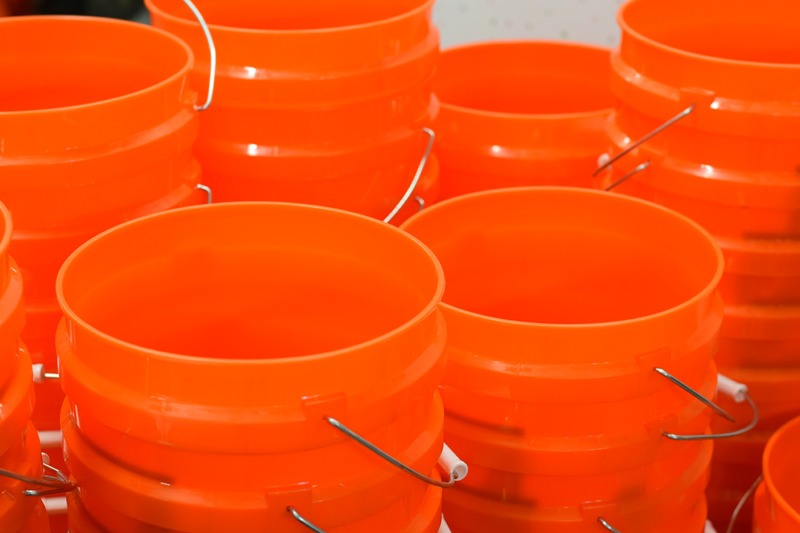 empty-orange-buckets-stacked-together