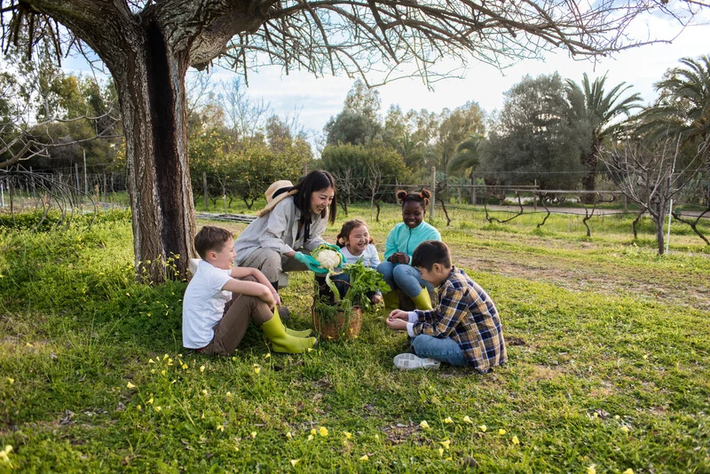 a woman and kids gardening