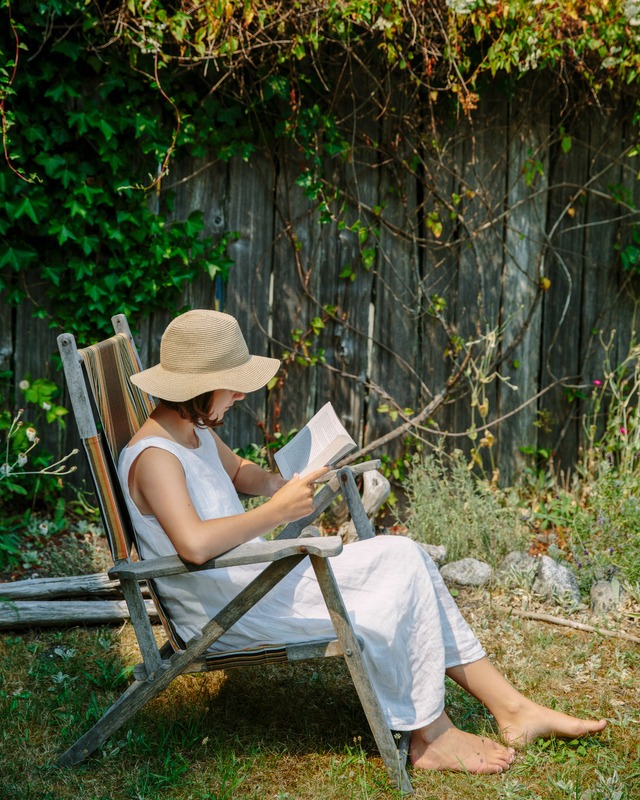 woman reading a book in the garden