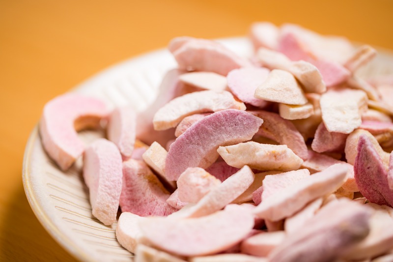 a close up image of a bowl of freeze dried peaches