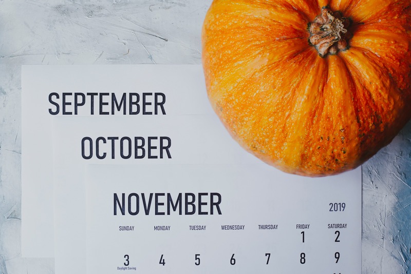 Autumn Months, Fall season concept. Three monthly calendars of September, October and November. Top view to calendars and pumpkin.