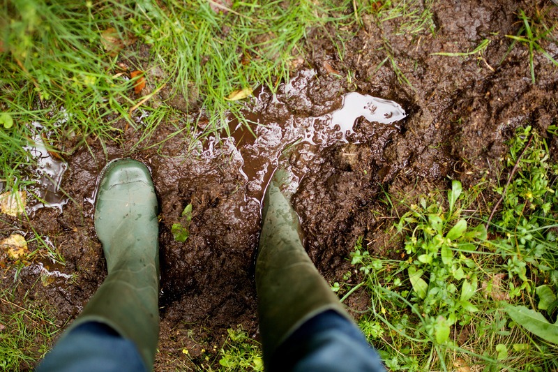 Top view rain boots in mud