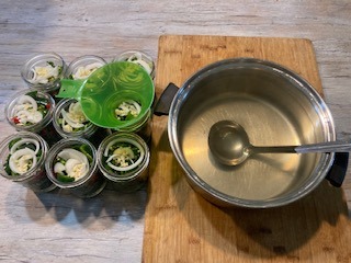 pickled pepper brine and peppers in the jar