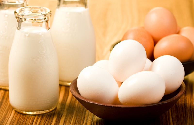 Milk and eggs on wood table