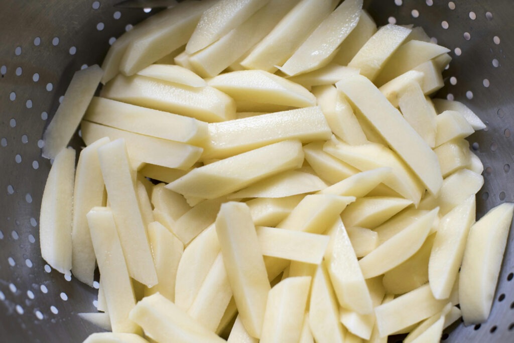 peeled and cut french fries ready for canning