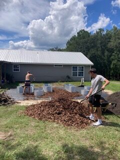 shoveling mulch into the pathways