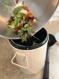 putting kitchen scraps in the container