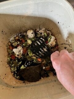 pressing down scraps in the bin