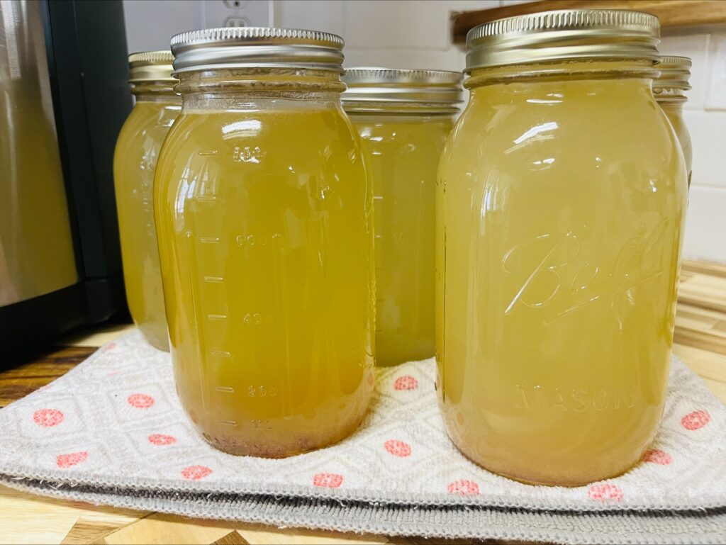 jars of finished chicken broth on counter